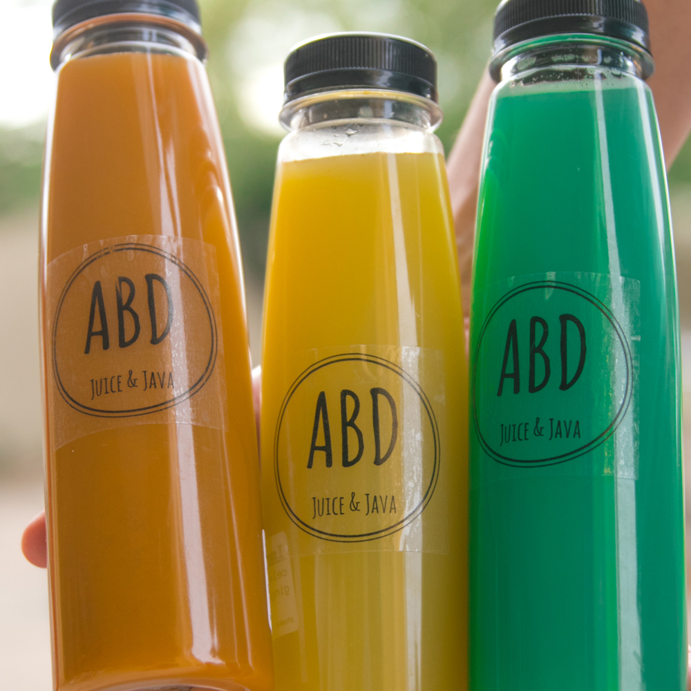 Bottles of cold-pressed ABD juice lined up in the cooler