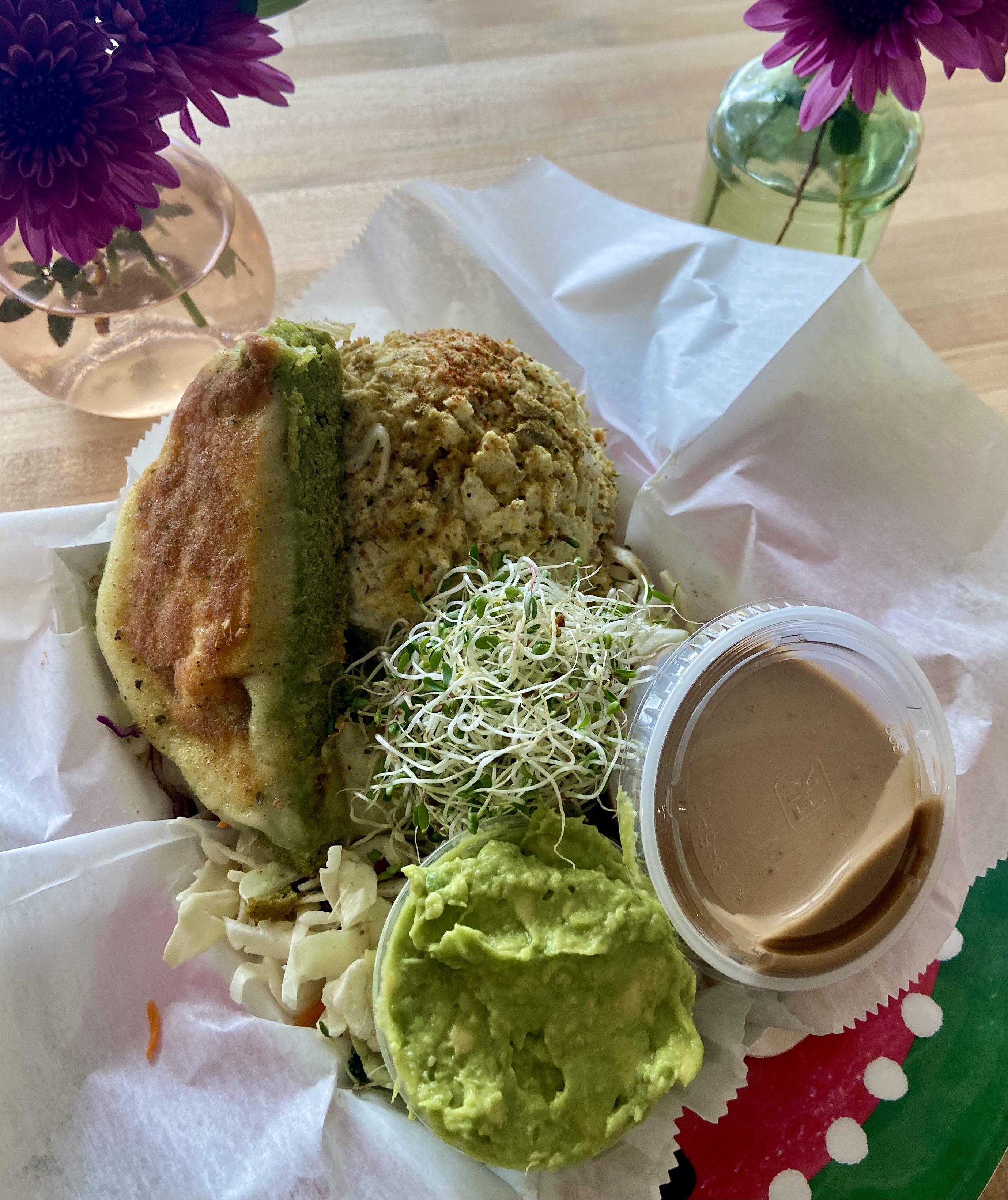 Falafel Protein Salad with a housemade falafel cake and a scoop of egg salad over the Super Salad
