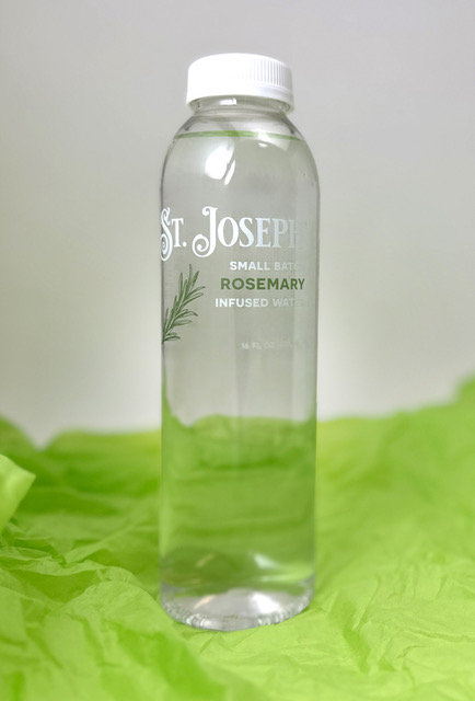Bottle of St. Joseph Rosemary infused water on a green backdrop