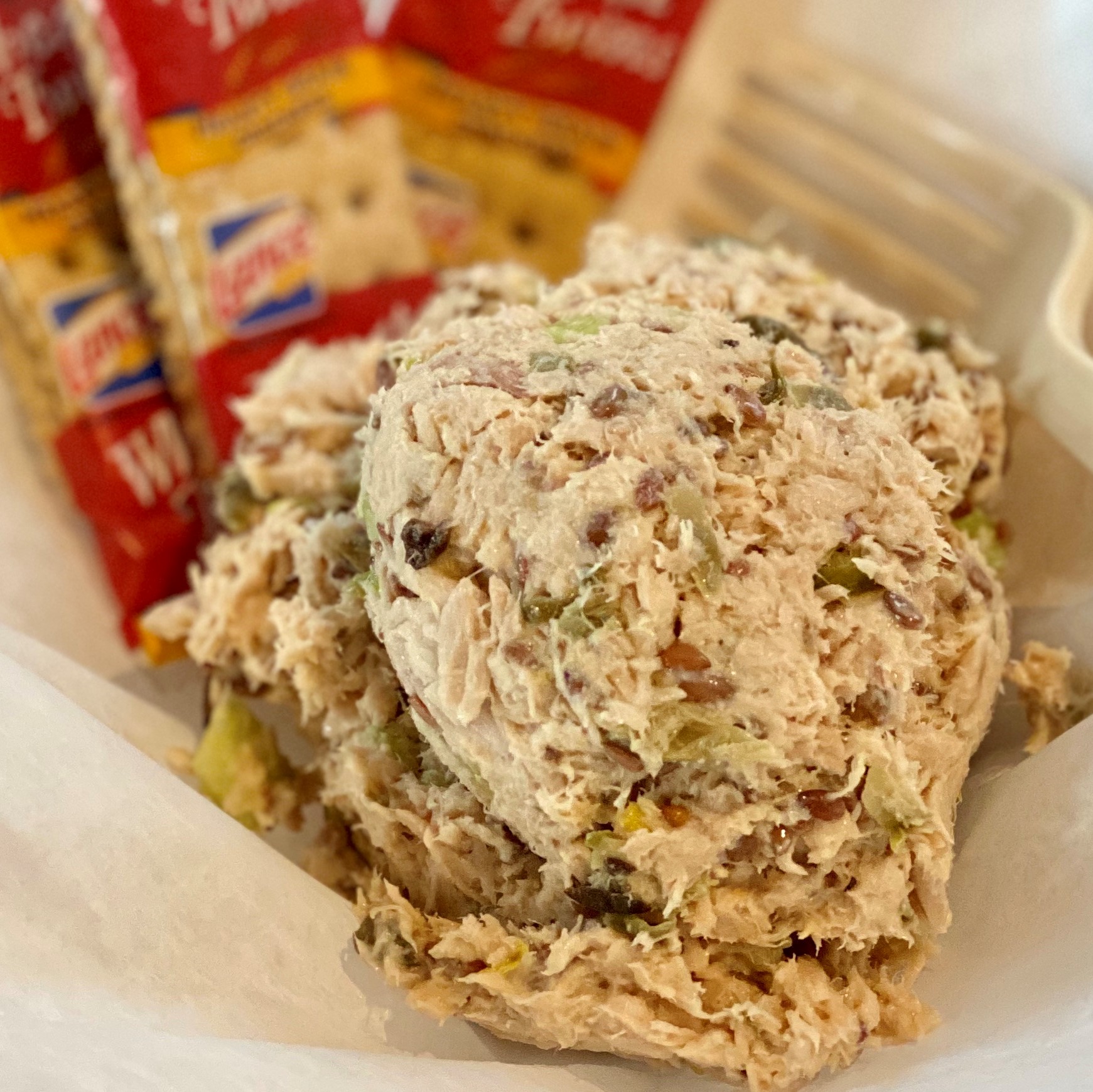 Scoop of house tuna salad with capers and green onion, served with crackers