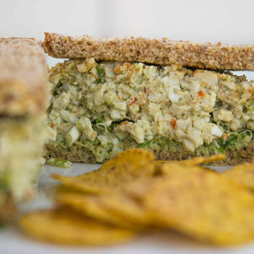 Egg salad sandwich with alfalfa sprouts on toasted 7-grain bread