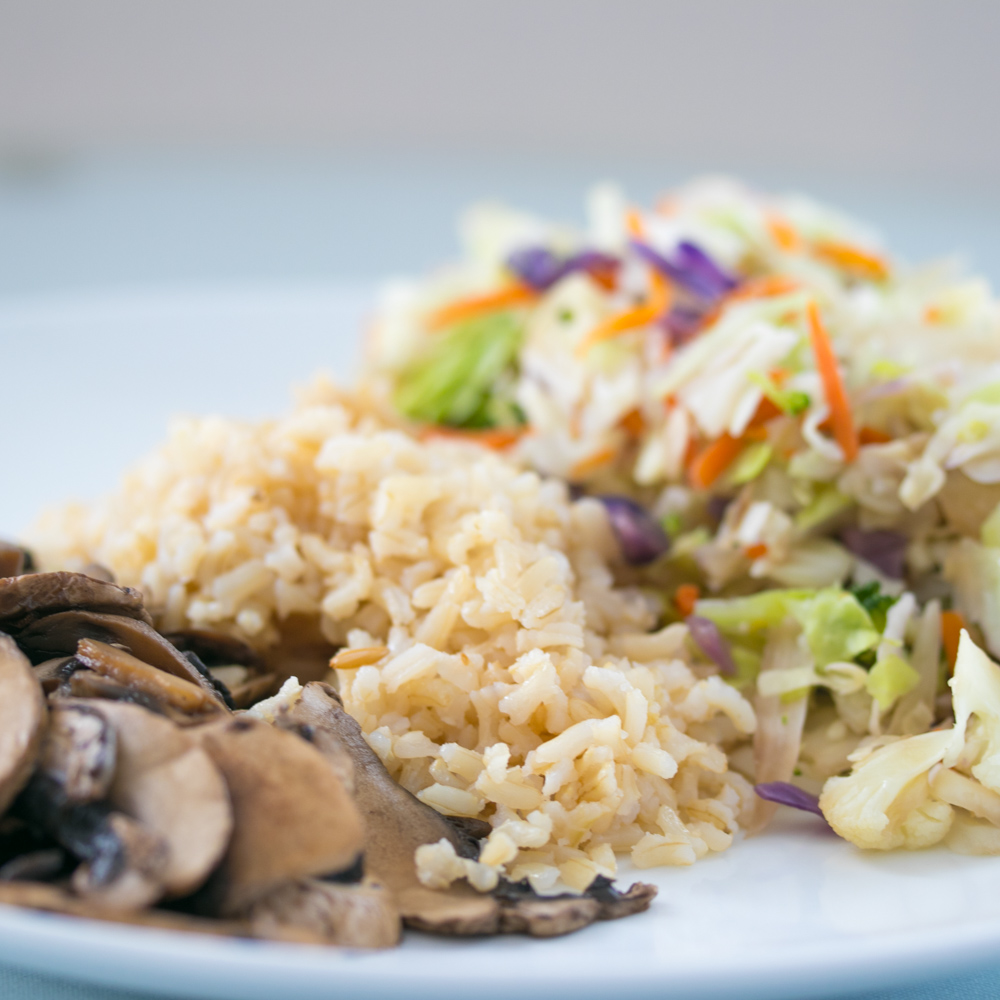 Vegetable Rice Plate with steamed rice, sauteed vegetables and a side salad