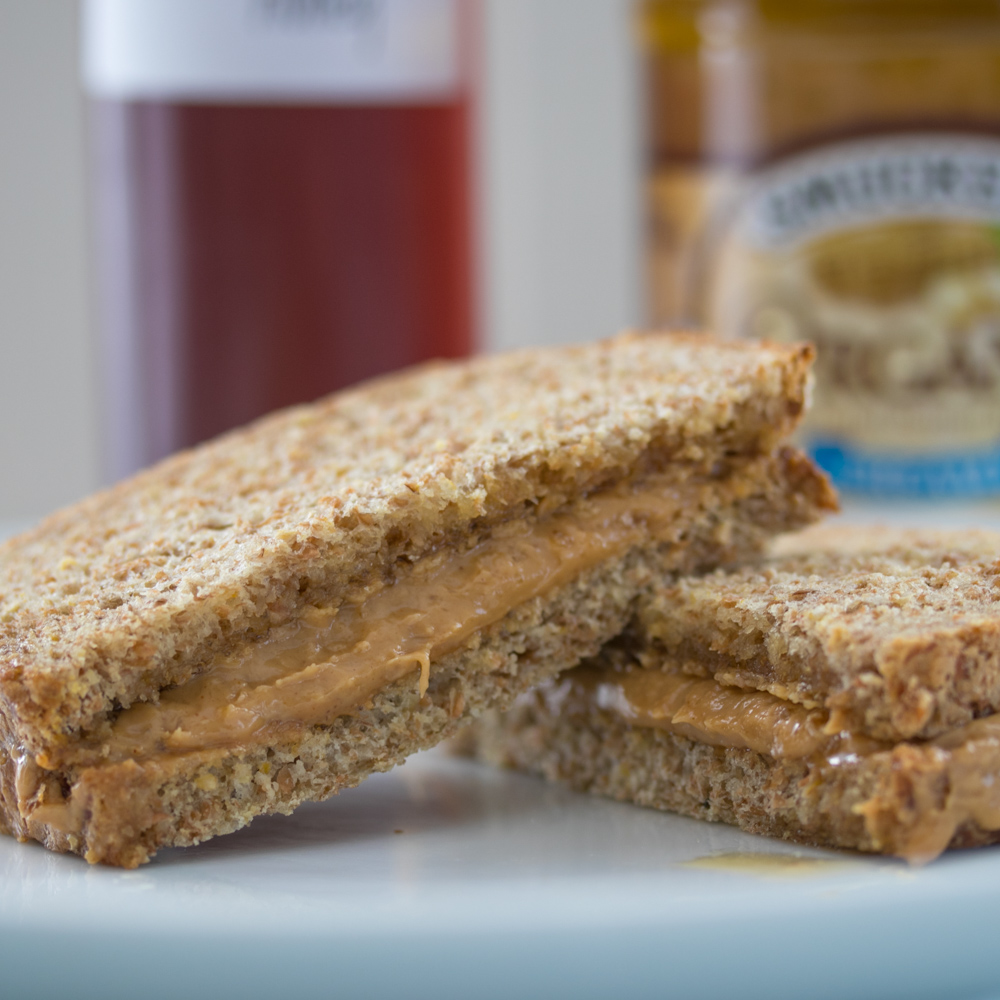 Peanut butter and honey sandwich on toasted 7-grain bread with chips